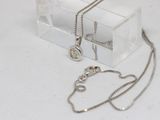 a clear box with a silver necklace and a silver chain