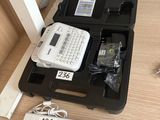 a black case with a keyboard and a remote on a table