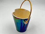 a blue and yellow bucket with a handle on a white table
