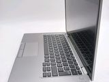 a silver laptop computer sitting on top of a white table