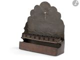 an old iron clock on a stand on a white background