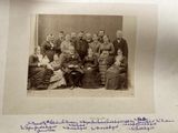 an old black and white photo of a group of people posing for a picture