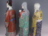 three asian figurines of women in kimono robes and hats