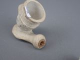 a small white pipe sitting on a table next to a smaller pipe