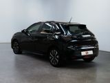 the back of a black car is parked in a room