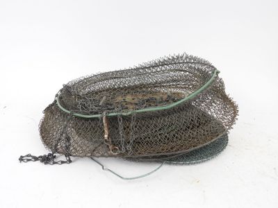 a basket with a fishing net on it on a white surface