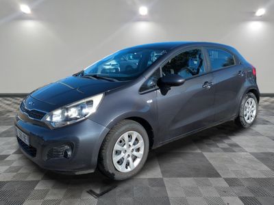 a grey car is parked in a room with a checkered floor