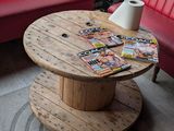 a red couch and a table with magazines on it