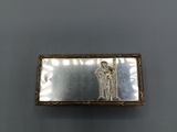 an image of a silver plate with a woman on it