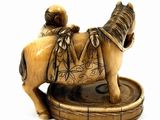 a figurine of a horse with a saddle on it