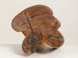 a wooden object that is sitting on a white surface