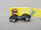 a pair of sunglasses sitting on a table next to a box