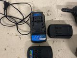 two batteries and a charger sitting on a table