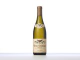 the bottle of white wine is sitting on the table