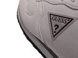 a close up of a white sneak with a guess logo on it