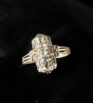 a close up of a diamond ring on a black cloth