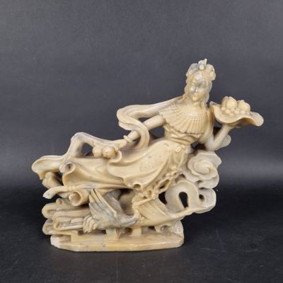 chinese carved ivory figurine of a woman sitting on a cloud