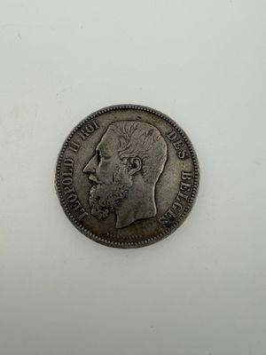 a silver coin with a man ' s face on it