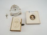 une petite boîte ornée d'une image, posée à côté d'un bougeoir et d'un chapelet
