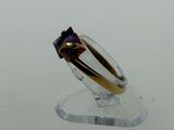 a ring that is sitting on top of a clear stand