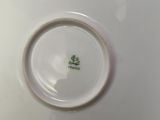a white plate with a green flower on it