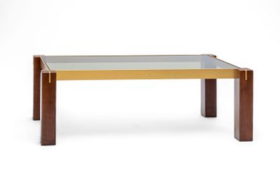 une table basse avec un plateau en verre et des pieds en bois