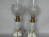 pair of antique porcelain lamps with gold trim and blue and white floral designs