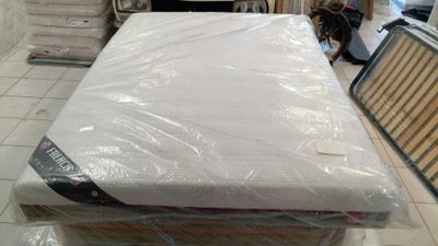 many mattresses stacked on top of each other in a room
