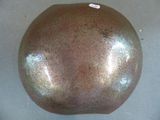 an image of a brown helmet with a tag on it
