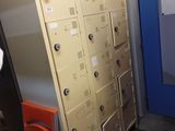 several lockers are lined up in a room with a blue door