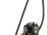 un aspirateur noir avec une poignée jaune sur fond blanc