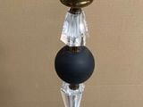 a lamp that is on a tripod on a marble floor