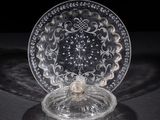 a close up of a glass plate on a table with a black background