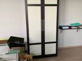 an image of a room with a trash can and cabinets