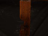 a close up of a wooden chair with a black background