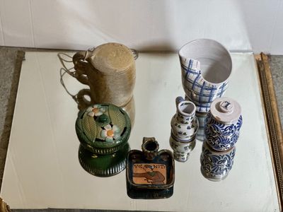a small table with a lot of vases on it