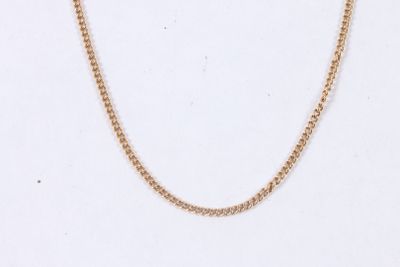 a close up of a gold chain on a white background