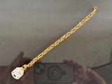 a person taking a picture of a chain with a cell phone