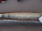 a small metal boat with a tag on it