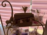 a table with various items on it in front of a window