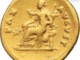 a close up of a gold coin with an image of a woman on a horse