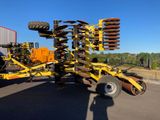 a close up of a tractor mounted on a trailer in a parking lot