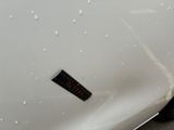 a sticker on the hood of a white car
