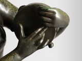 a statue of a woman holding an apple in her hands