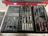 many tools in a tool box on the floor