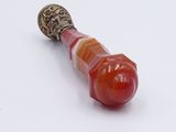a red and orange object on a white surface