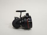 a close up of a fishing reel on a white surface