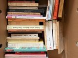 a box full of books that are stacked on top of each other