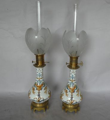 pair of antique porcelain lamps with gold trim and blue and white floral designs