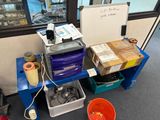a desk with a lot of items on it in a room